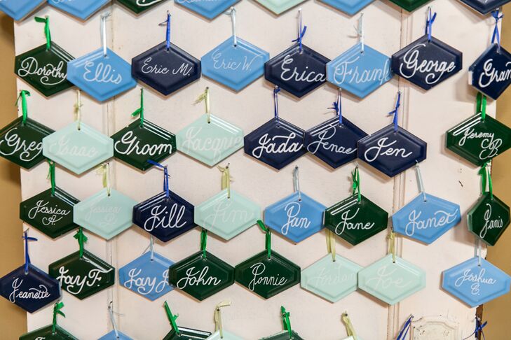 Guests' names were painted on porcelain tiles in the wedding's color scheme. These served as the escort cards and favors. Seeing the tiles hanging in friends' and families' homes after the wedding “has been such an honor,” Marla says.
