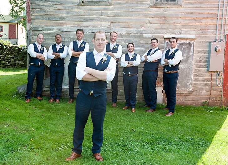 Sam and his groomsmen wore navy linen vests and ties opting not to wear the matching jackets to better match the casual atmosphere of the barn wedding at Maple Shade Farm.