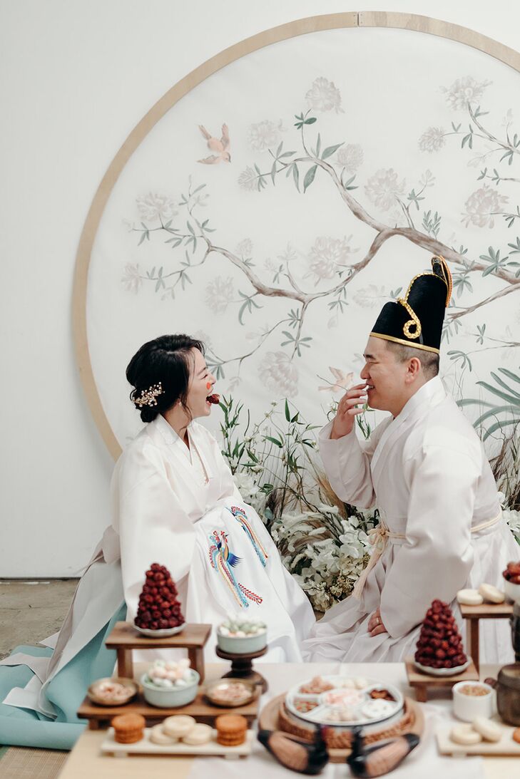 Bride and Groom in Traditional Hanbok Robes in Pastel Colors Performing Korean Paebaek Ceremony, Hand-Painted Backdrop