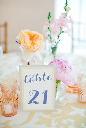 Pink and Orange Floral Decorations with Table Numbers