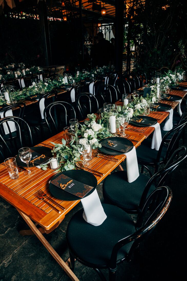 Long Dining Tables, Black and Gold Details, Greenery Runners, Black Chairs and Low Lighting