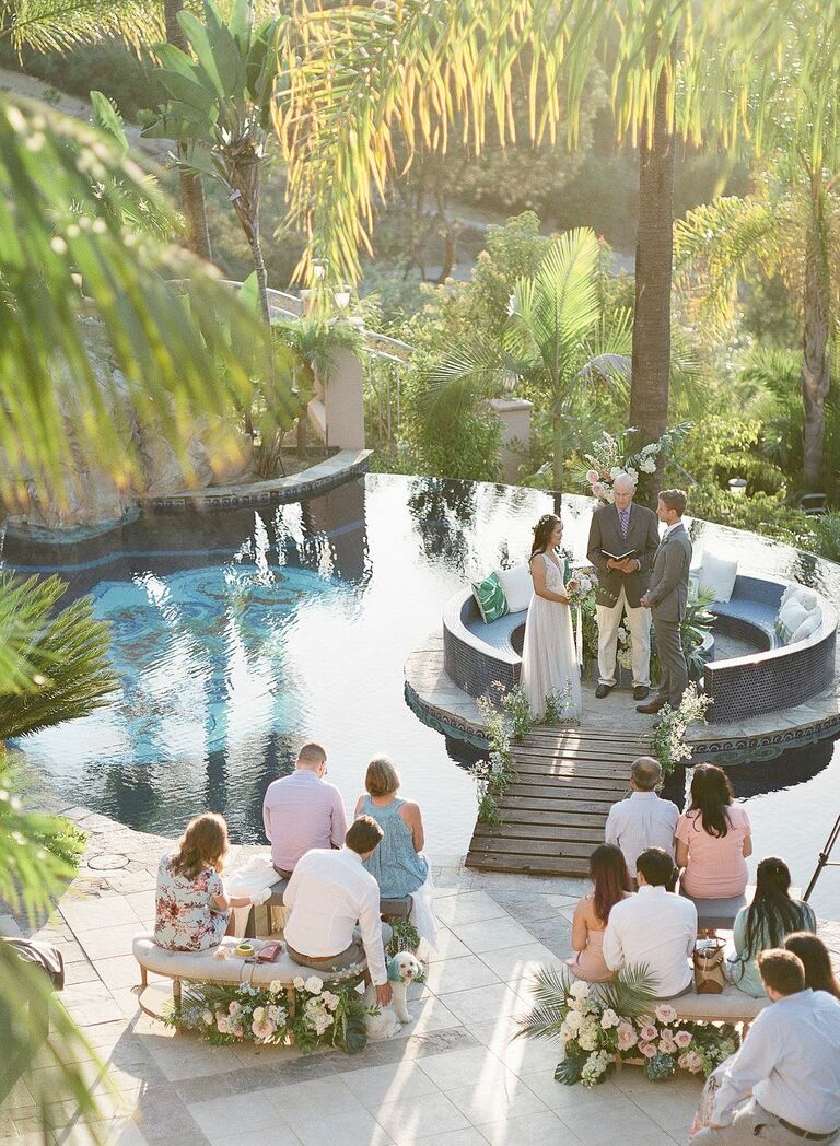 Couple exchanging vows beside swimming pool