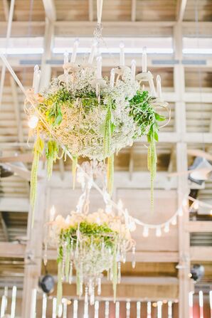 White Chandeliers Draped With Greenery