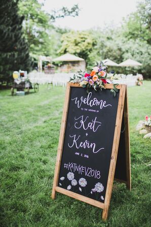 Chalkboard Welcome Sign with Drawn Flowers and Summer Floral Arrangement