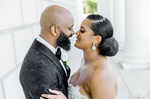 Bride With Slick Updo and Groom in Detail Black Jacket Embrace