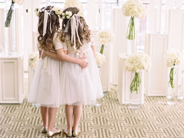 Flower girls wear their hair in loose curls complete with flower crowns. 