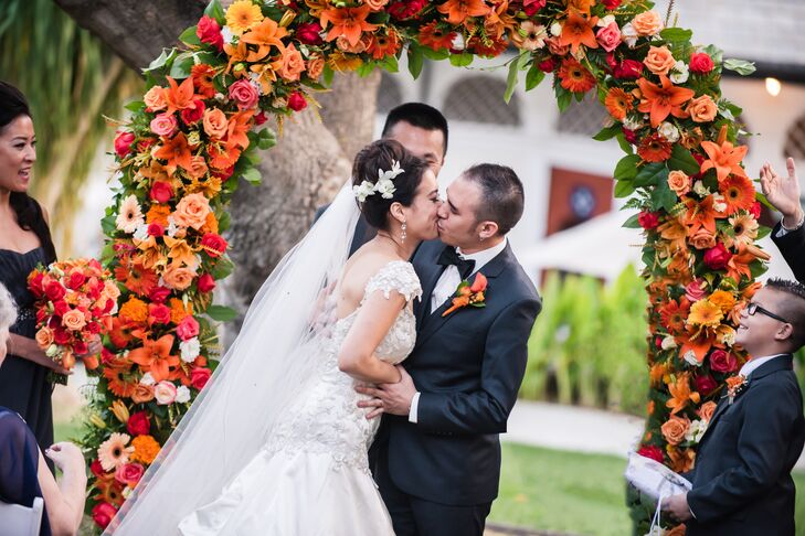 "There was an arch that we wanted to be decorated with the orange flowers. It turned out better than what we had in mind.  It was full and bright, bursting with the orange flowers," says Chantley.