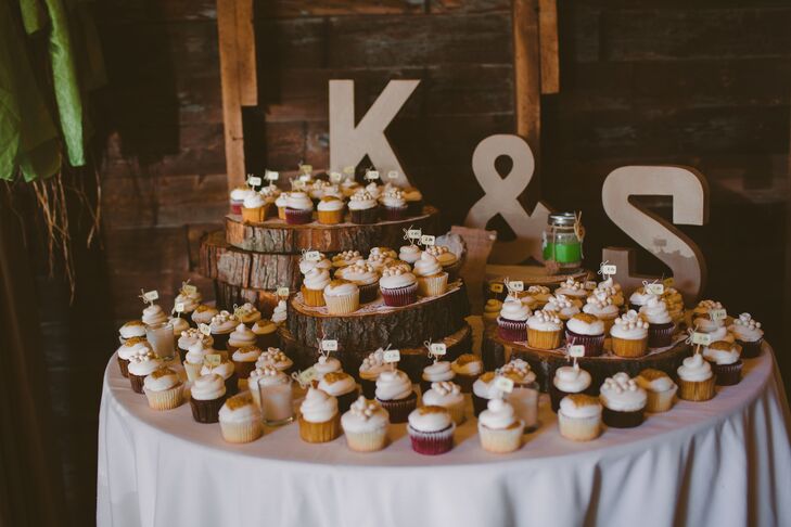 Instead of a traditional wedding cake, Kaitee and Spike had a variety of cupcakes for dessert. The cupcakes were displayed on tree rings along with the couple's monogram on the dessert table.