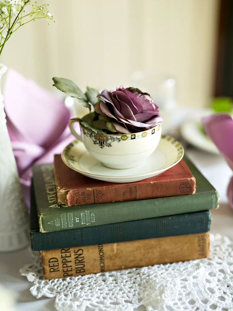 Vintage books and antique teacup centerpiece for your Disney-themed wedding