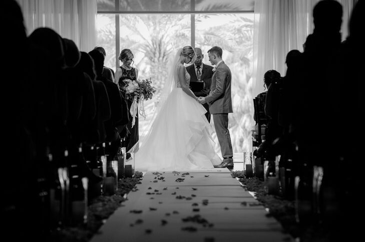 Thick beds of flower petals lined the aisle for the ceremony along with tall candles placed in glass vases. “My husband and I individually selected all the songs to be played acoustically on a guitar during the ceremony, and it was such a special touch. Every song meant something personal to us,” Millie says.