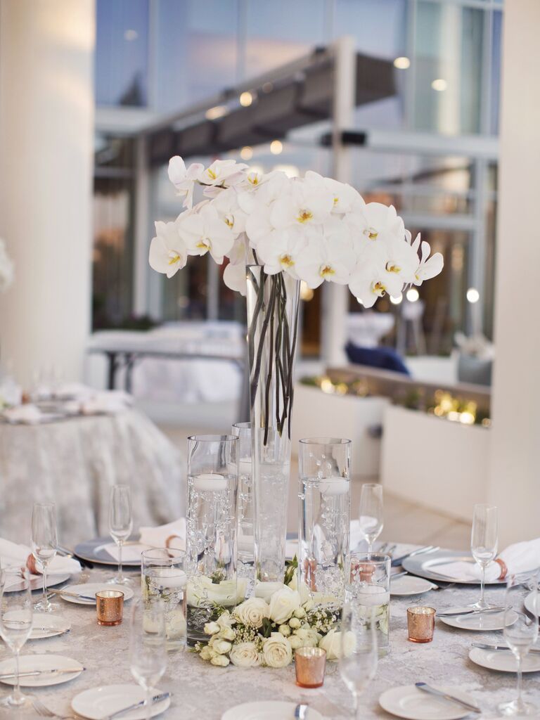 modern tall wedding centerpiece with white phalaenopsis orchids in glass vase