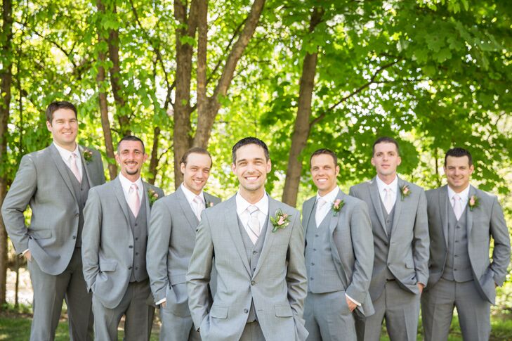 Groomsmen wore gray suits with blush colored ties and simple rose boutonnieres.