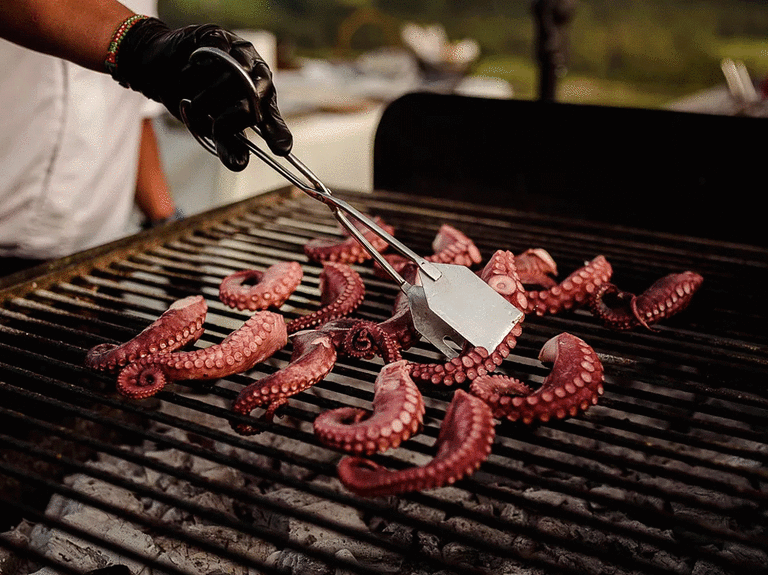Chef grilling octopus at a winter wedding.