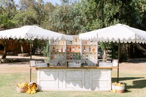 Vintage Wooden Bar Under Scalloped Umbrellas on a Lawn With Lemon Decor