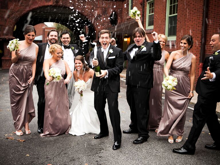 Bride and groom showered with champagne after wedding. 