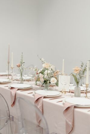 Long Reception Table With Blush Linens, Ghost Chairs, Varying Low Centerpieces and Tall Candles