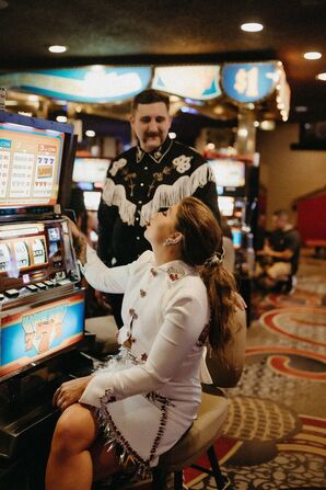 Couple Playing Casino Slot Machine During Vow Renewal in Las Vegas