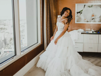 Bride getting ready in ruffle halter wedding dress