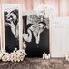 Seating Chart Display With Black-and-White Engagement Photos. White Roses and Orchids