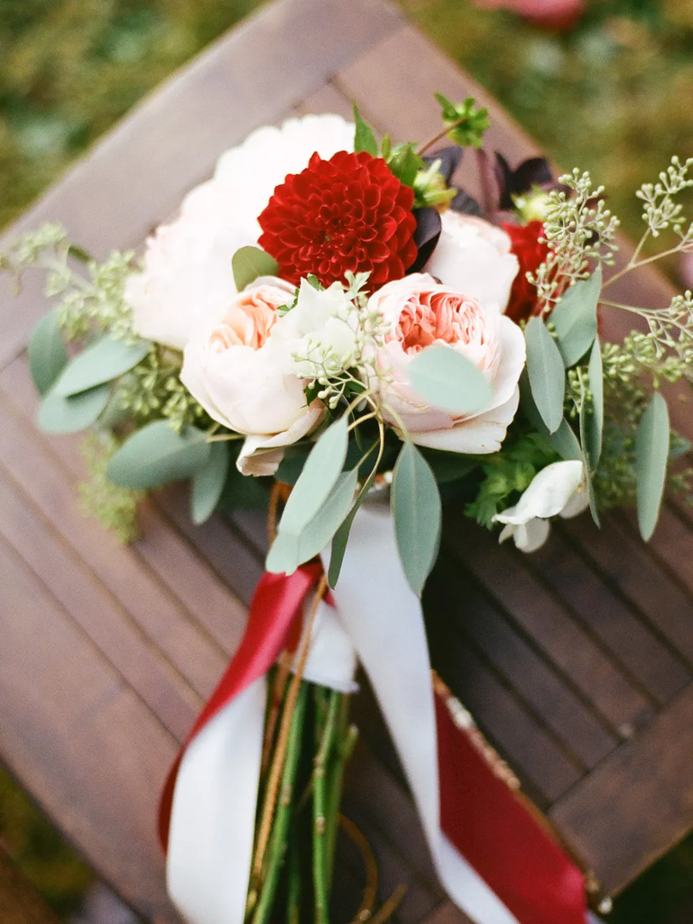 A gorgeous red and pale pink dahlia and rose bouquet.