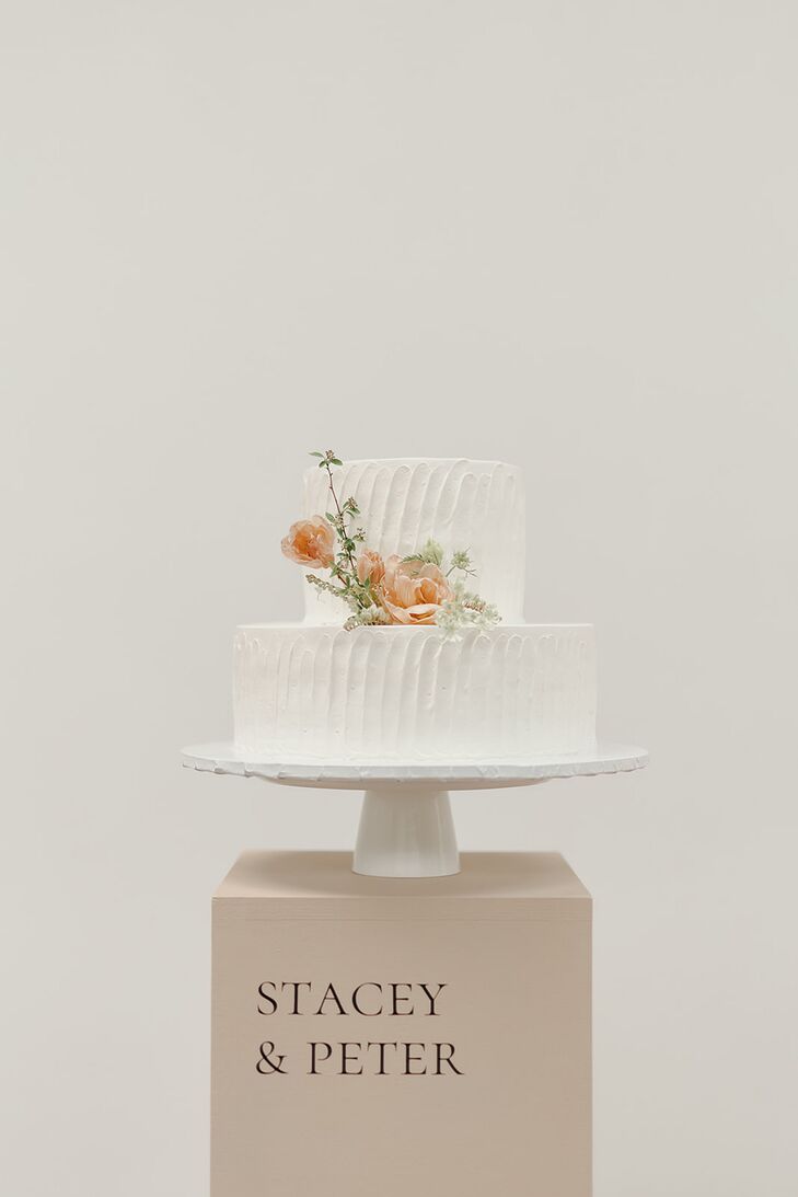 Two-Tier White Wedding Cake With Textured Frosting, Pastel Flowers and Custom Stand