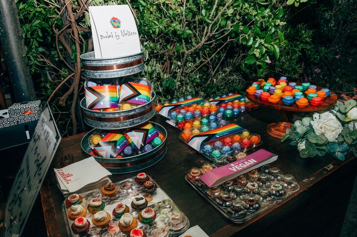 Dessert Table With Mini Cupcakes, Macarons Featuring Rainbow Colors, Progress Pride Flag for LGBTQ+ Wedding