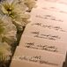 As a way to tie in fancy elements, rows of fresh white dahlias were placed alongside the escort cards.
