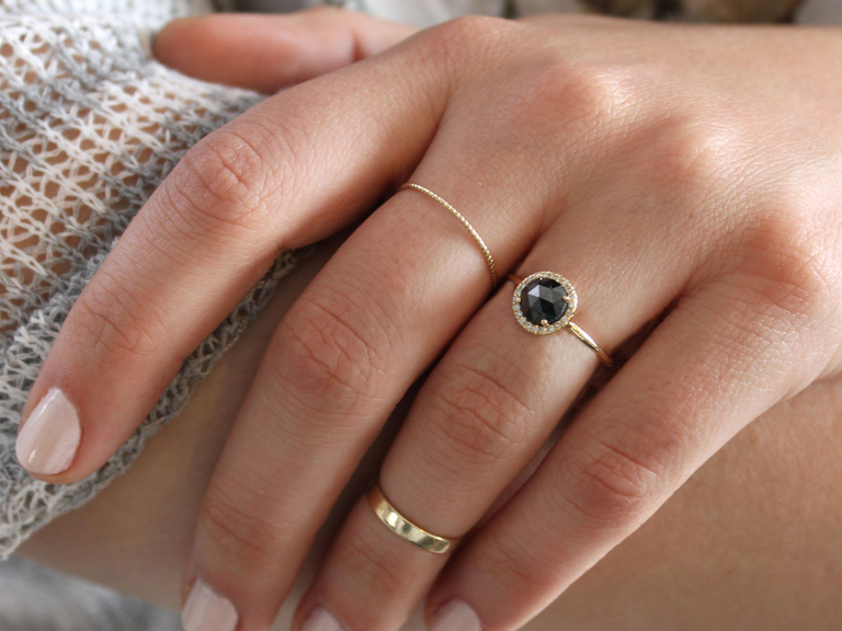 This black diamond ring, encircled by small white diamonds, is giving us serious Breakfast at Tiffany's vibes.