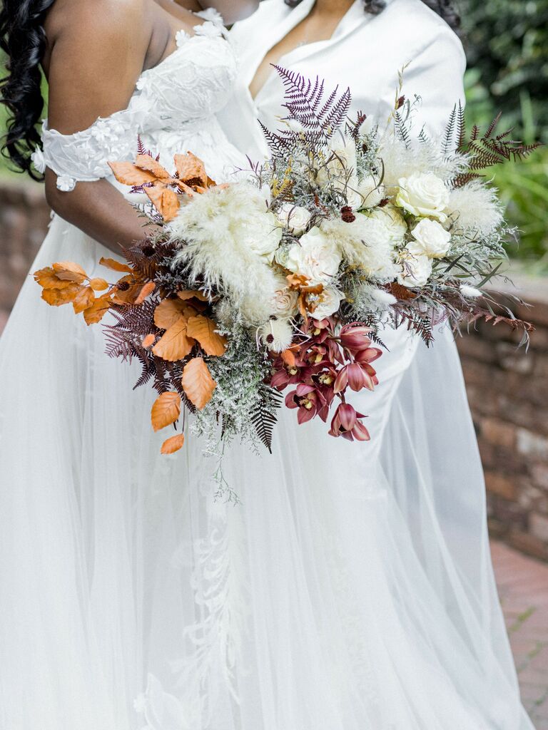 unique fall wedding bouquets with ferns, orange leaves, red orchids and pampas grass