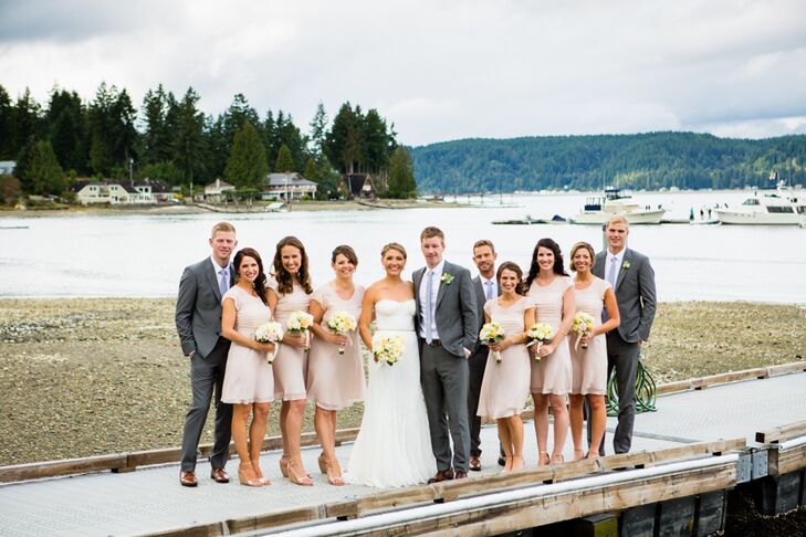 Michelle and Jeff stood on the dock surrounded by their bridesmaids and groomsmen, dressed in accents of champagne and light gray. The bridesmaids dressed in sleeved champagne-colored dresses with matching wedges, while the groomsmen sported light gray suits paired with light gray ties.