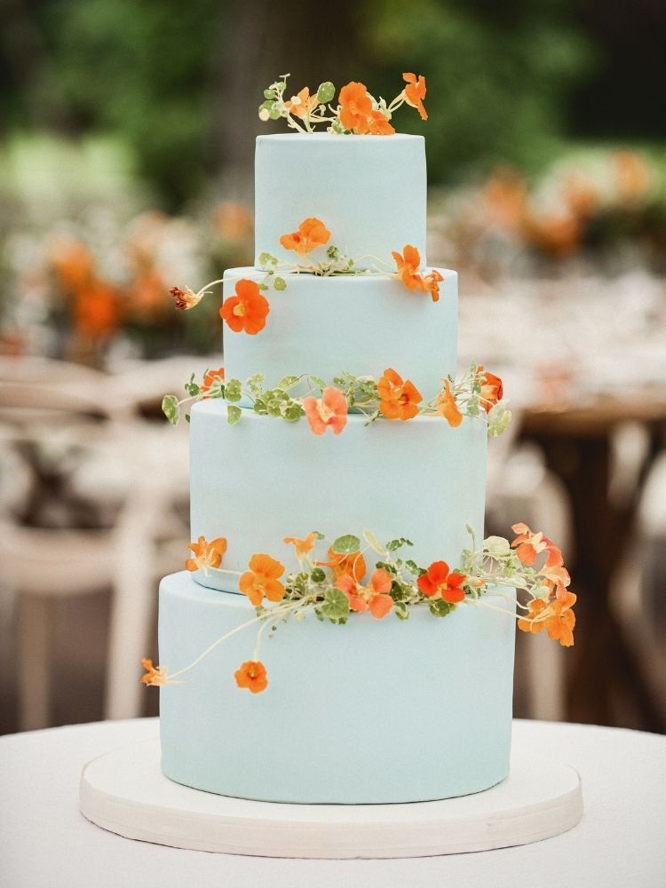 blue wedding cake with orange flowers