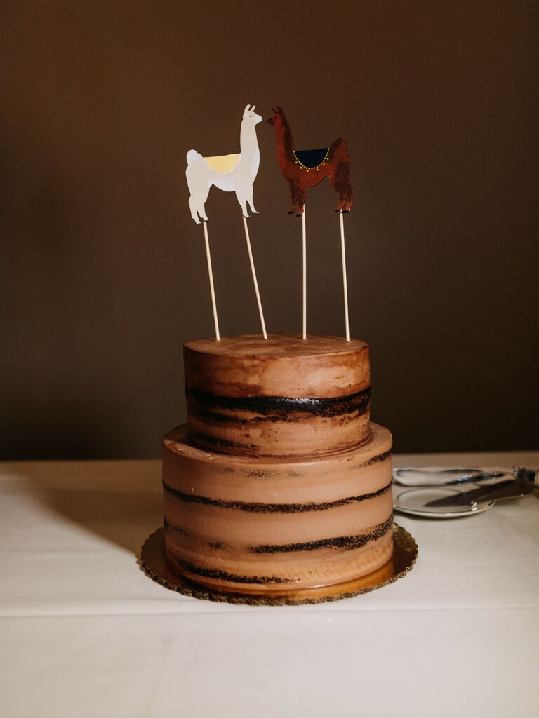A white and brown llama and alpaca hand-made cake toppers. 
