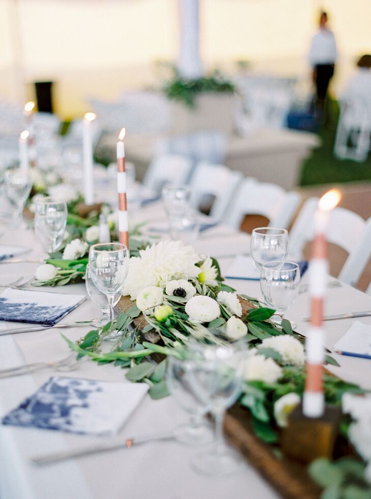 The centerpieces were the reception’s piece de resistance, with fresh herbs, sweet peas, dahlias, ranunculus, tulips, anemones, ferns, eucalyptus and more bringing life to the foraged wooden planks and crisp white linens.