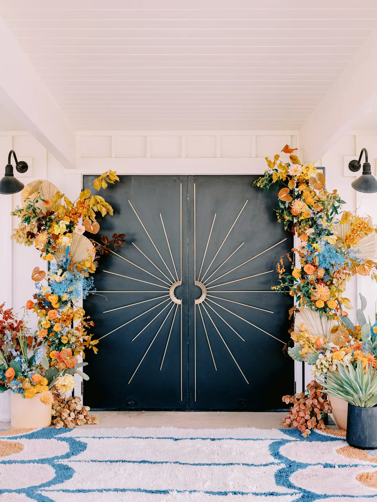 Autumnal floral arrangements frame this stunning art deco doorway.