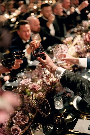 Wedding Guests Toasting With Red Wine During Reception Dinner