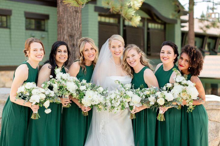 Bridesmaids in Long Green Dresses Holding Rose, Ranunculus and Lisianthus Bouquets