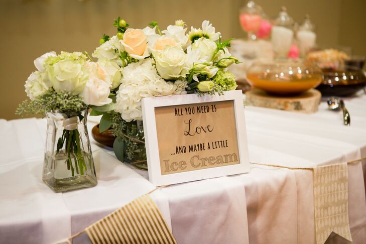 At the reception, a sign that read "All you need is love and maybe a little ice cream" marked the ice cream bar location. In addition to the savory treat, guests also enjoyed the two-tiered wedding cake designed to look like a birch tree.