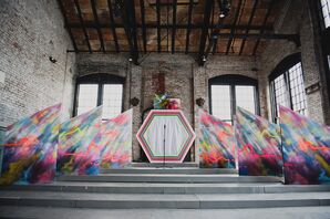 Altar in Warehouse Ceremony Space With Custom Dyed Structures and Neon Hexagonal Arch