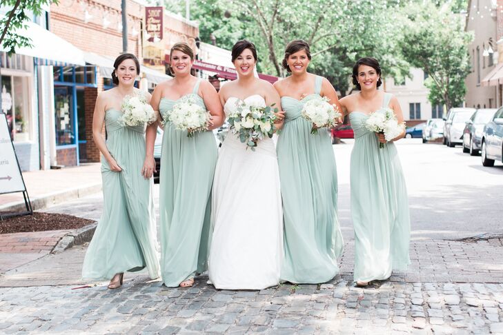 Mary Kait's four bridesmaids wore the same mint Bill Levkoff dress. The sheath-style gowns were one-shouldered, and the ladies wore their hair up to show off the sweetheart neckline.