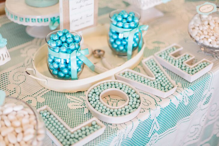 Cami loves blue-green colors, such as aqua and turquoise, so it was no surprise that their candy bar was filled with sweets in those same hues. After dinner, they opened a blue and white candy bar from Florida Candy Buffets with rock candy, gum balls, jelly beans and more.