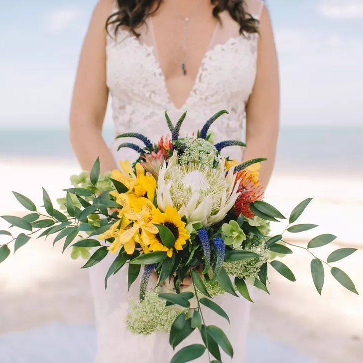 Sunflower and protea wedding bouquet for a beach wedding