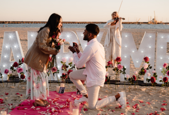 Man proposing to woman on the beach 