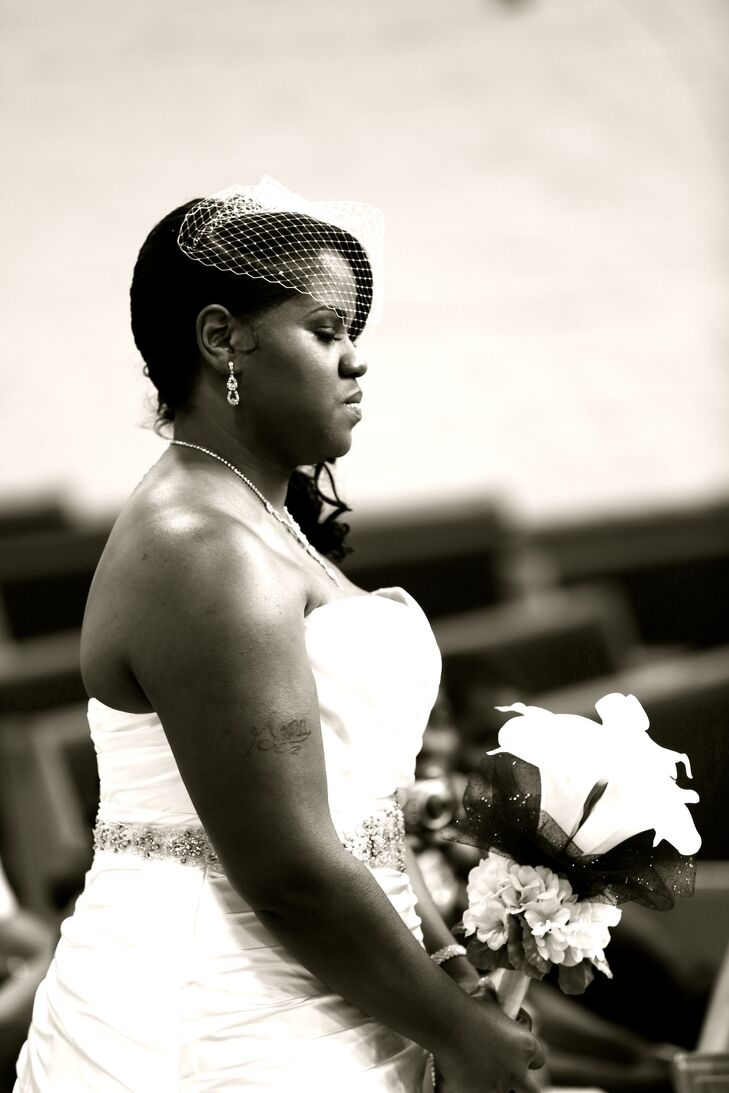 Gena walked down the aisle wearing her ivory strapless wedding dress accented with a crystal belt.