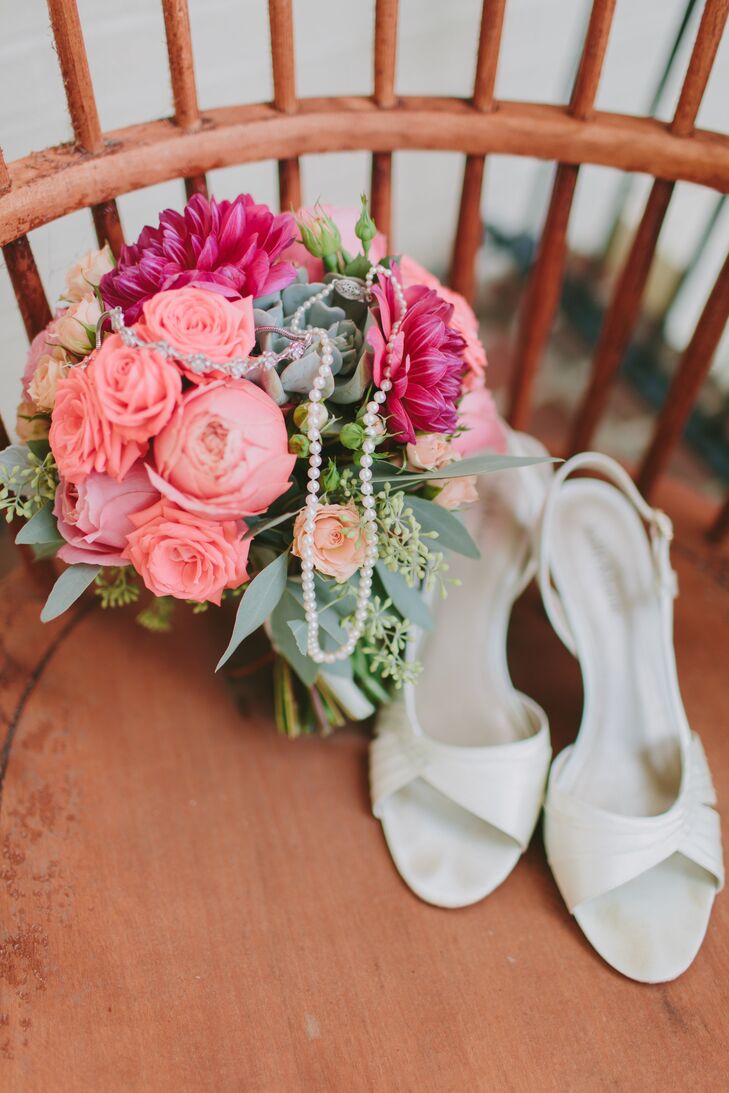 Brittany's bridal bouquet combined coral-toned flowers, including spray roses, garden roses, dahlias, succulents, dusty miler and eucalyptus.