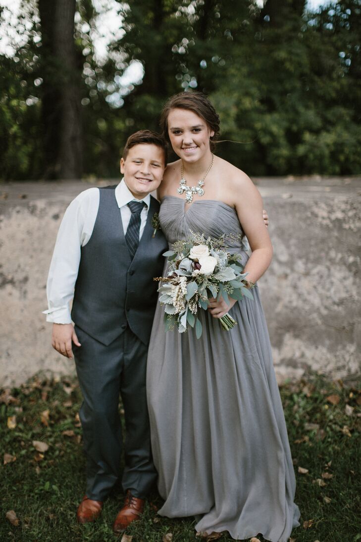 Angela's maid of honor was Dan's daughter, Bella. She wore a soft, strapless gray gown and statement necklace from J.Crew. Angela's son, Jack, wore gray pants and vest and brown leather wingtip Oxford shoes. He also donned astronaut print socks. "He took great joy in knowing he got to pick out a fun little component of his outfit for the ceremony," Angela says.