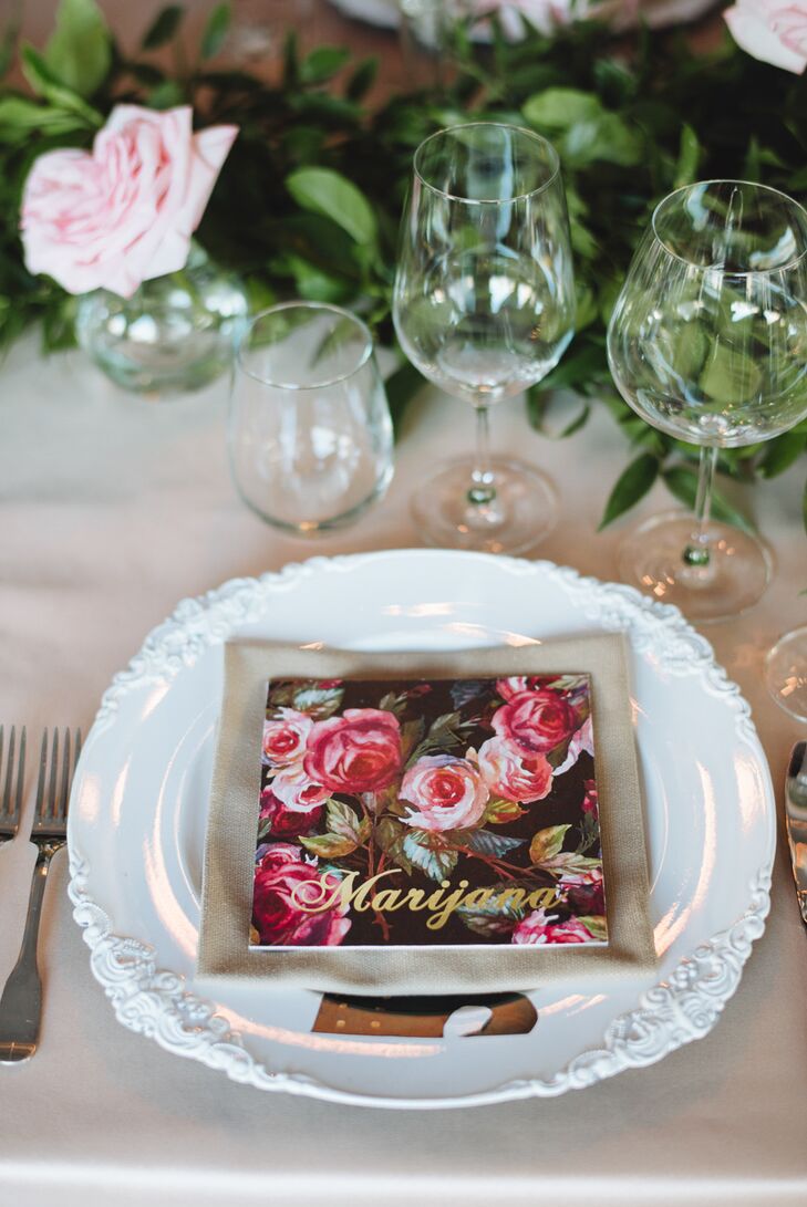 The newlyweds played up the secret garden theme with personalized botanical place cards adorned with gold script. The cards popped against intricate white dinnerware while drawing attention to the soft pink roses woven into the leafy garland that ran the length of the table.