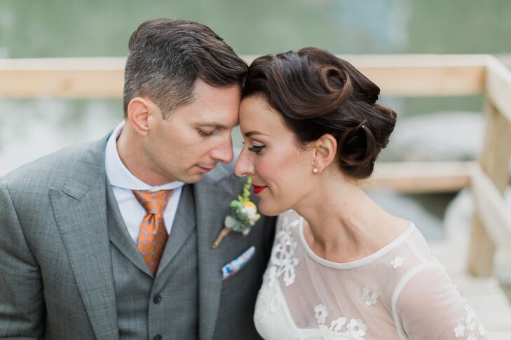 Jennifer's hair and makeup, done by stylist Erica at Lather and makeup artist Erin Winters, evoked a 1940s feel. She wore her hair in a classic updo with romantic pin curls and an embellished accessory on one side. As for her makeup, emphasis around her eyes and a bold red lip completed her style.