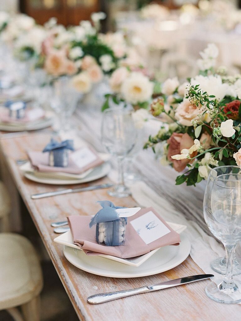 place setting with macaron wedding favors in clear gift box tied with ribbon