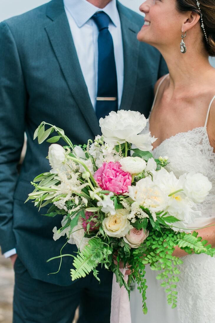 Lauren gave her florist Watershed Floral full reign when it came to her bouquet. Capturing the natural essence of the day, the team put together a stunning arrangement of roses, ranunculuses, peonies and ferns with an untamed, romantic appeal.