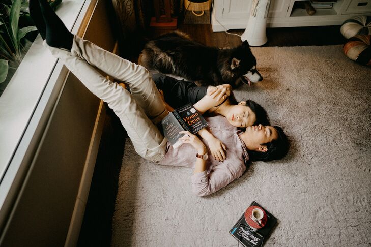 Couple Snuggling on the Floor With Dog